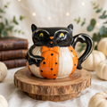 Bat Mug by Johanna Parker Design for Transpac styled with vintage books, cream pumpkins, and eucalyptus