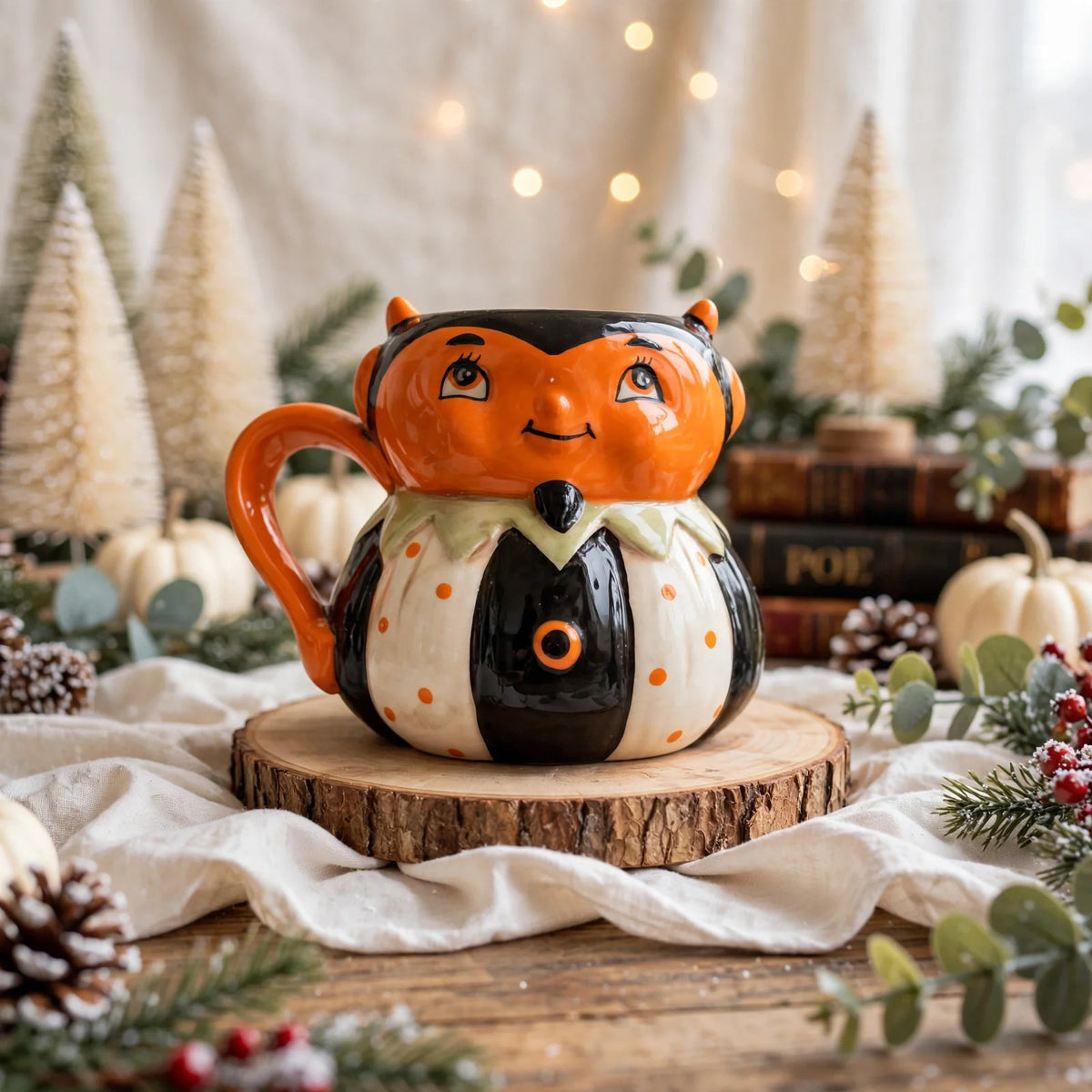 Devil Mug by Johanna Parker Design for Transpac styled with bottle brush trees, winter greenery and vintage books