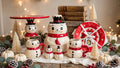 Johanna Parker Design for Transpac snowman 10-piece curated Christmas set styled with bottle brush trees, berries and vintage books