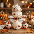 Johanna Parker Design Mummy Collection styled with pumpkins, autumn leaves, and warm lights