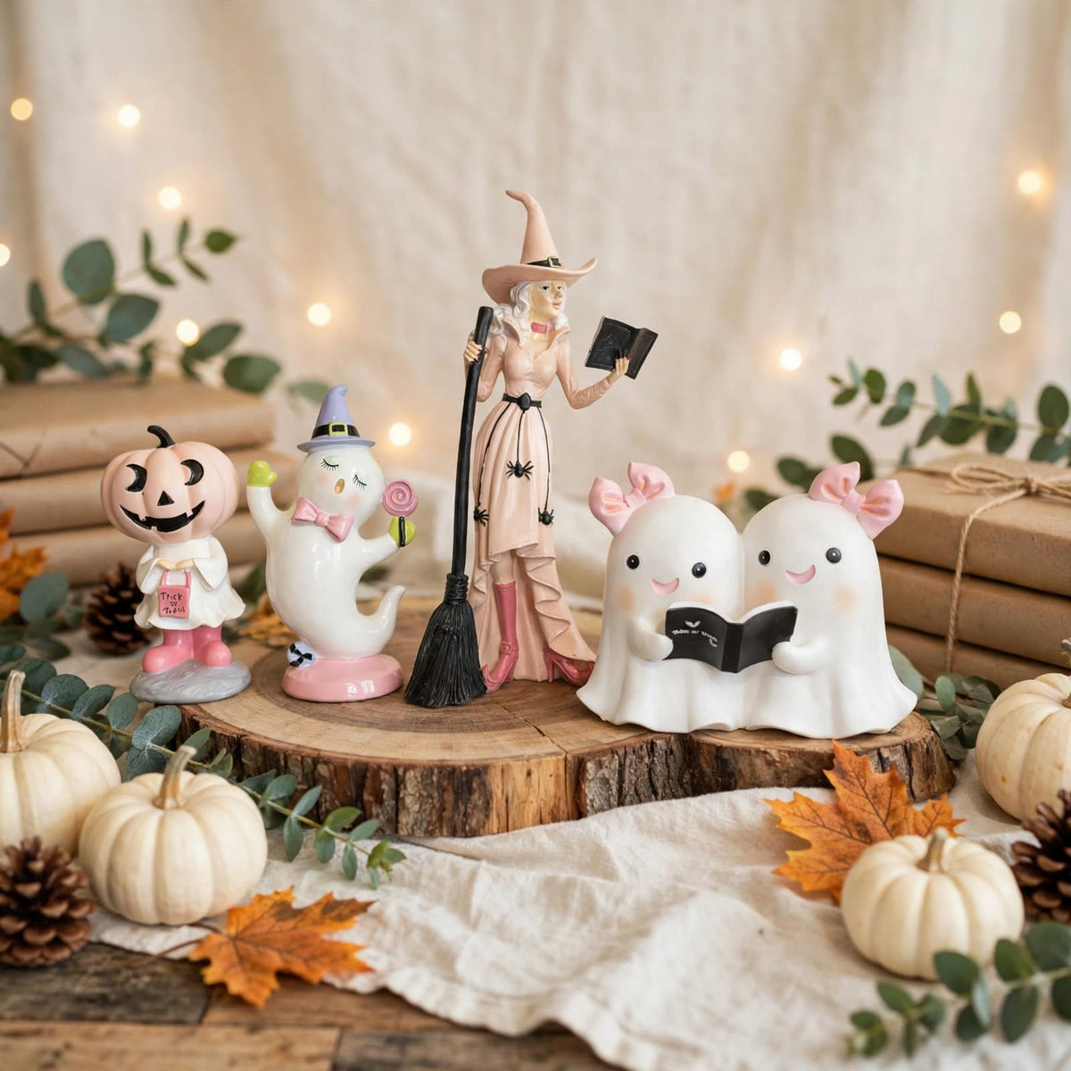 Pastel Halloween figurine set with pink witch, ghosts and pumpkin characters styled in a fall display